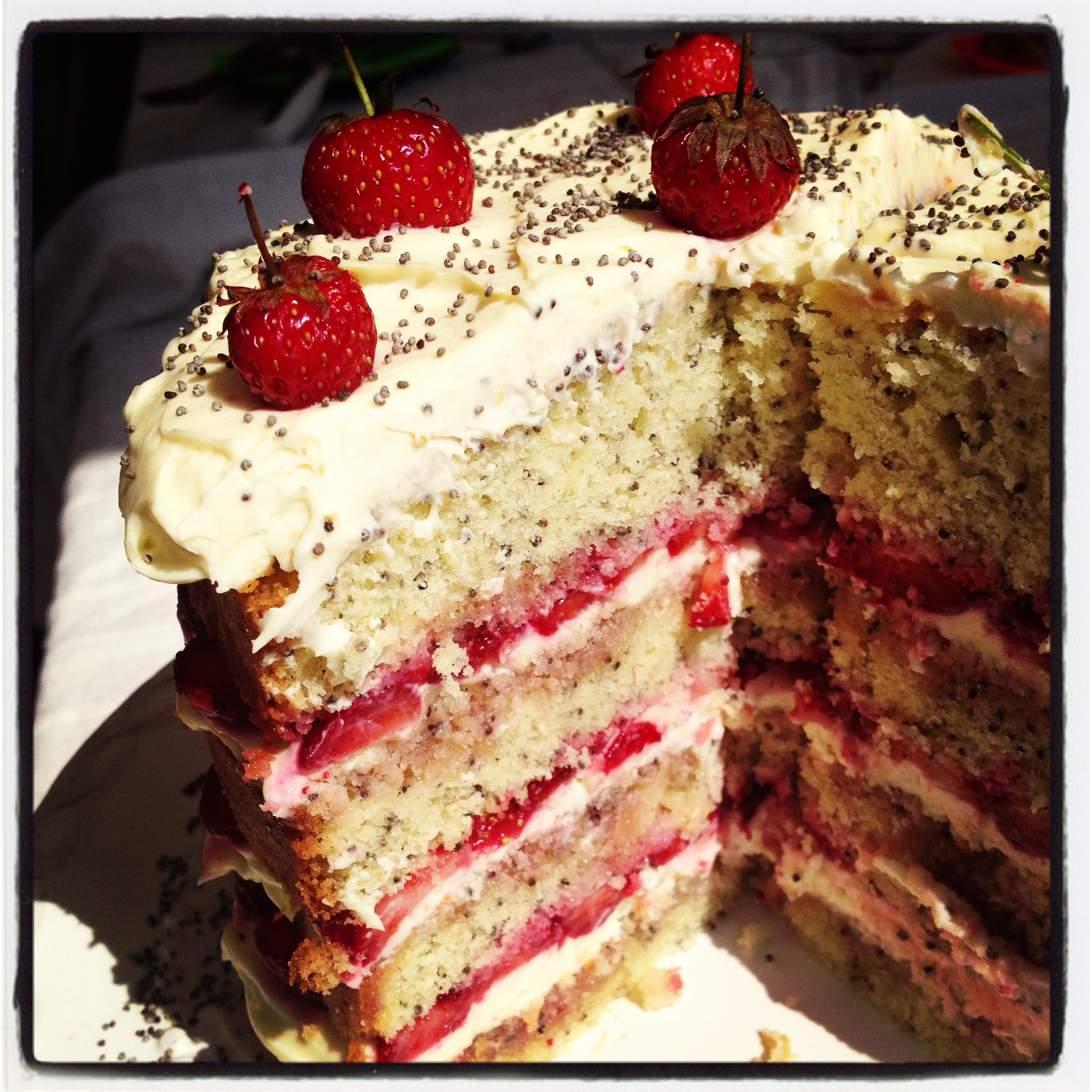 Orange vanilla cake with poppy seeds and strawberries