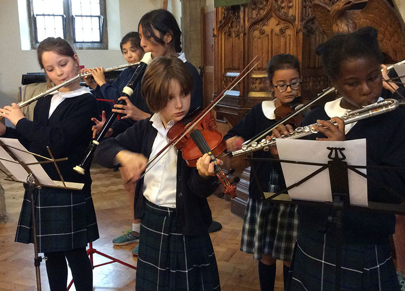 Falcons School for Girls perform a music ensemble at the Harvest Festival